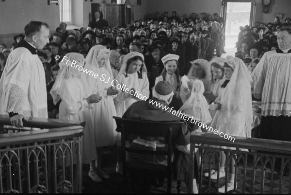 BISHOP EXAMINING CHILDREN